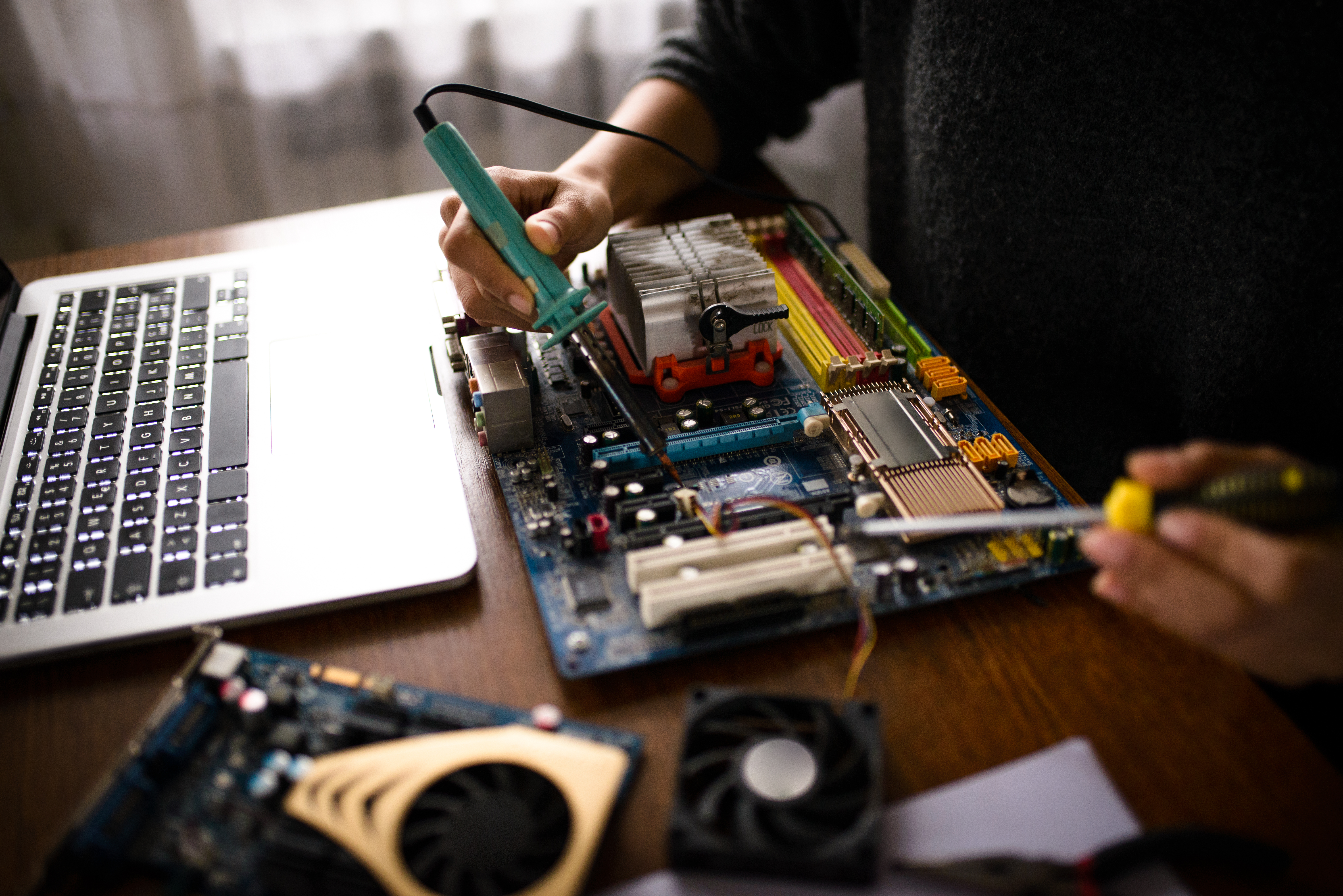 Close up of a woman hands repairing computer
